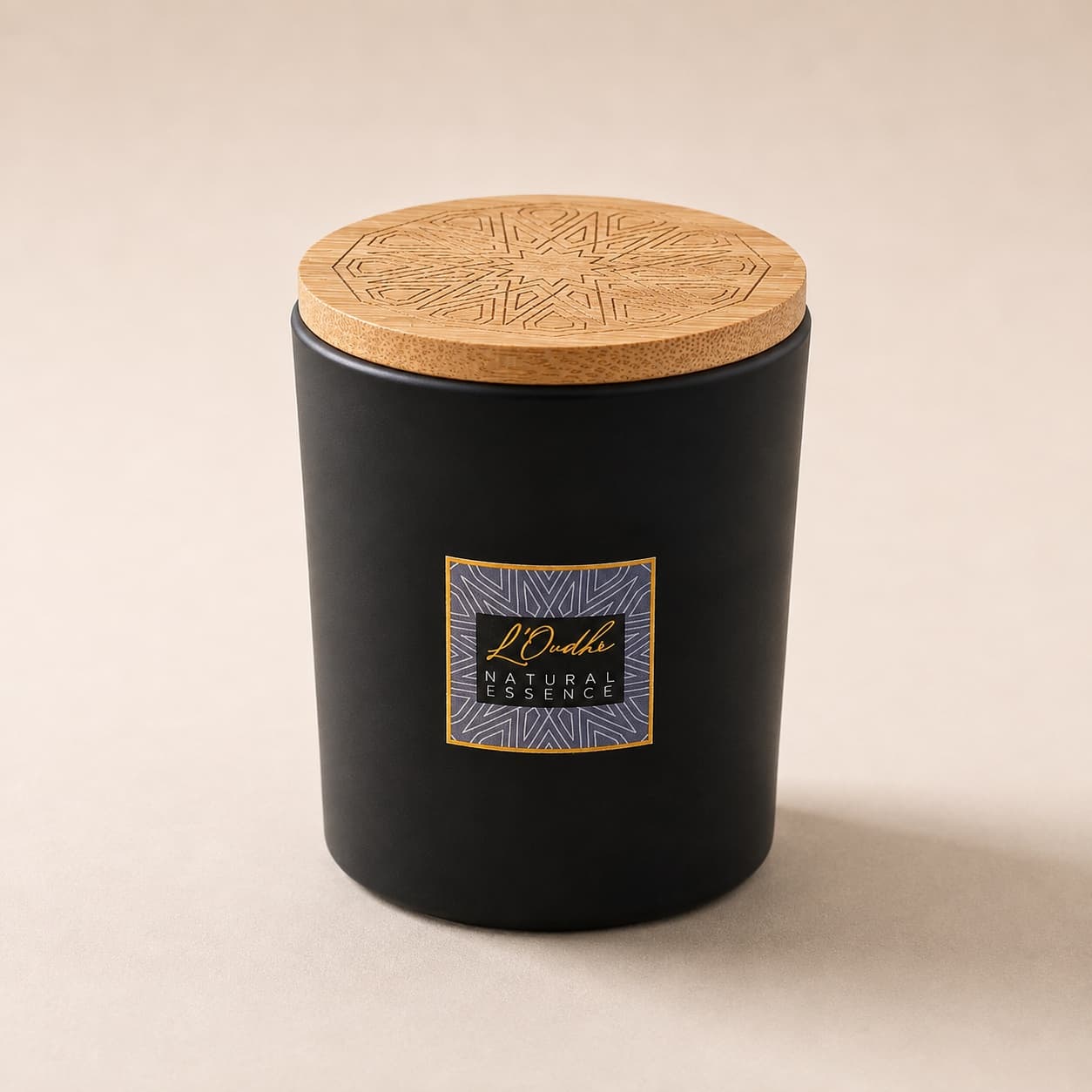 The Wellness Retreat candle: a matte black jar with a slate and gold zellige label, closed with an engraved wooden lid.